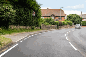 What does the white line along the side of the road indicate? - Theory Test