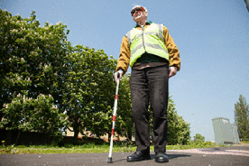 What does it mean if you see a pedestrian carrying a white cane that has a  red band or bands wrapped around it? - Theory Test